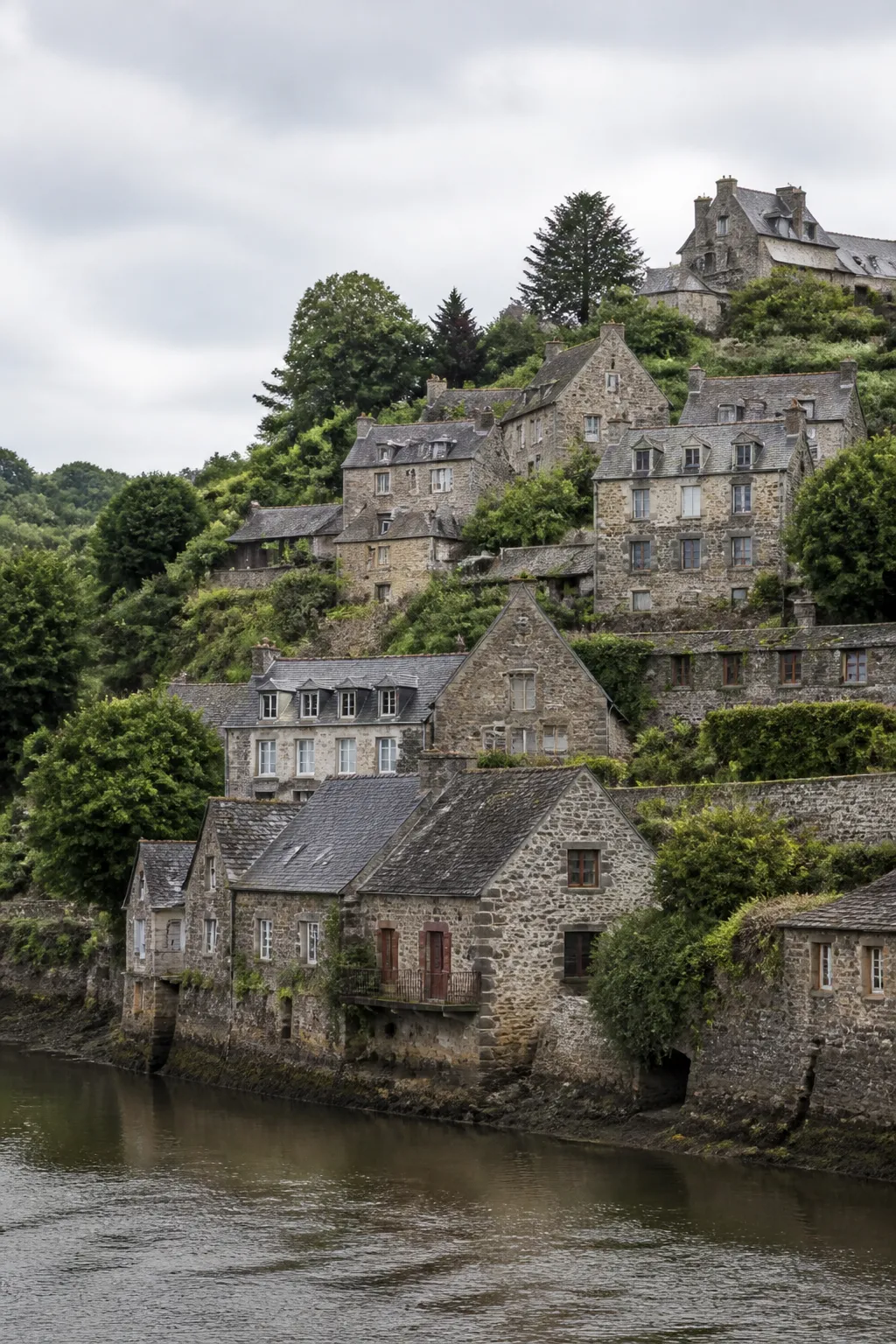 Maisons en pierre sur un coteau dominant une rivière en Bretagne