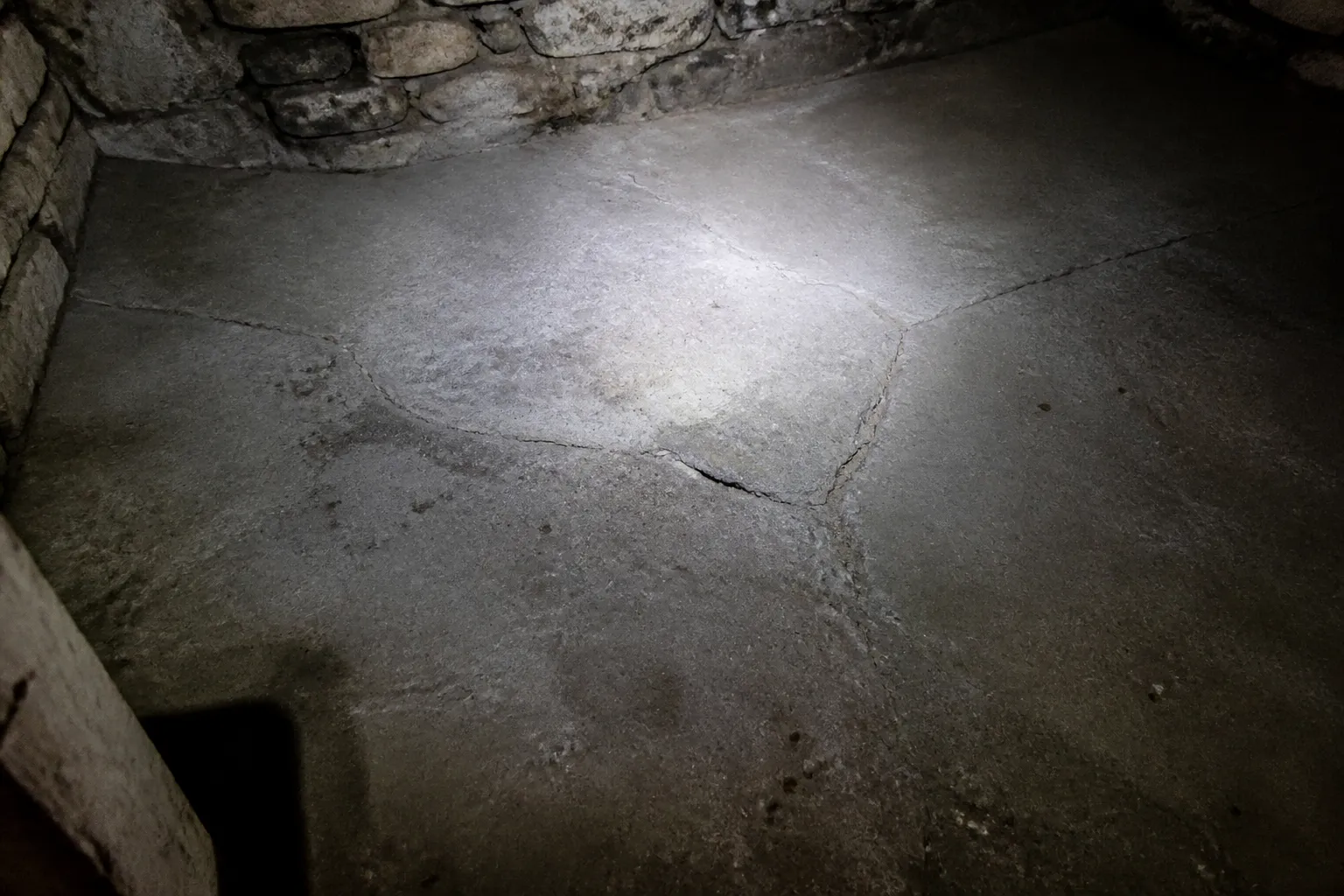 Dallage de cave affaissé observé à la lampe