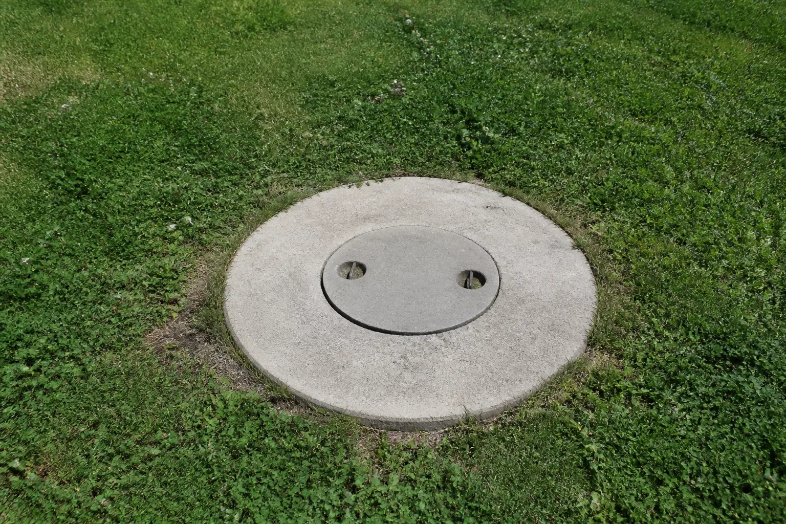 Regard de fosse septique dans le jardin d’une maison individuelle
