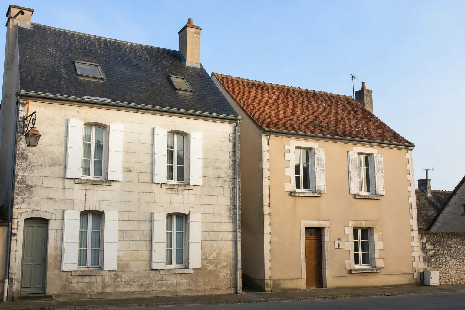 Deux maisons voisines de styles différents dans une rue d’une petite ville du Centre-Val de Loire